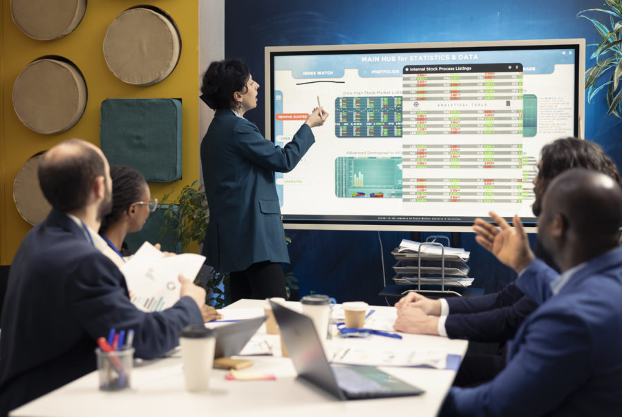 Business partners examining sales reports in a meeting