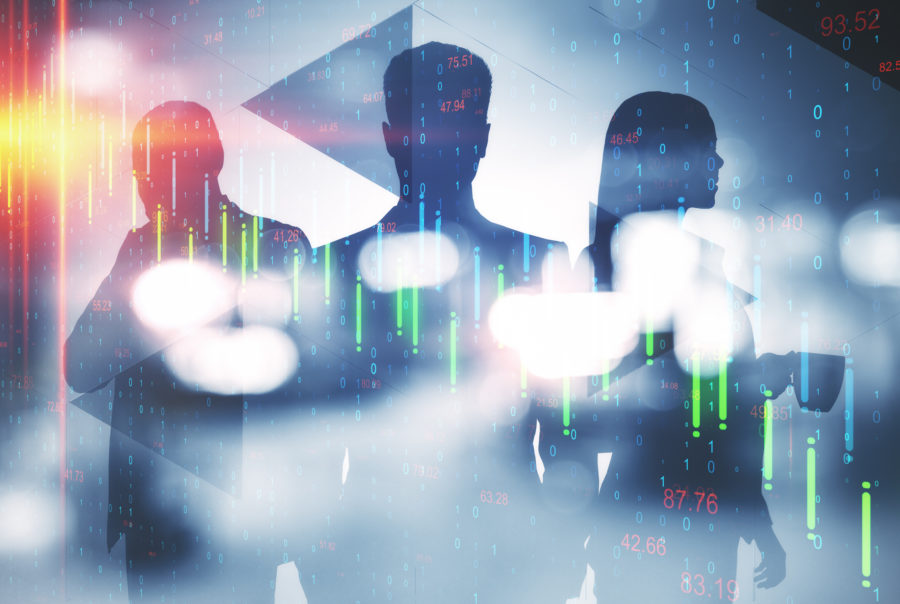 Business people silhouettes against financial market data