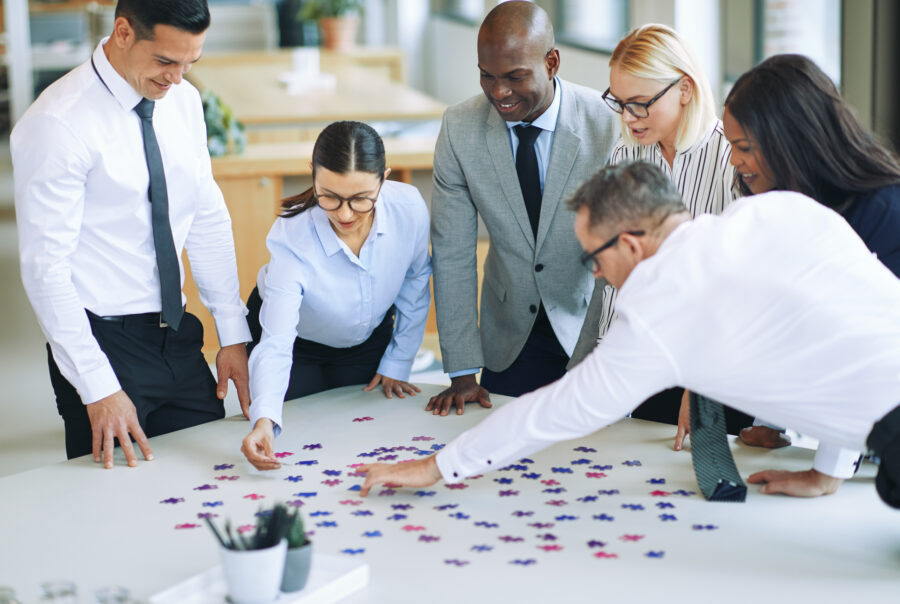Business people solving a jigsaw puzzle together