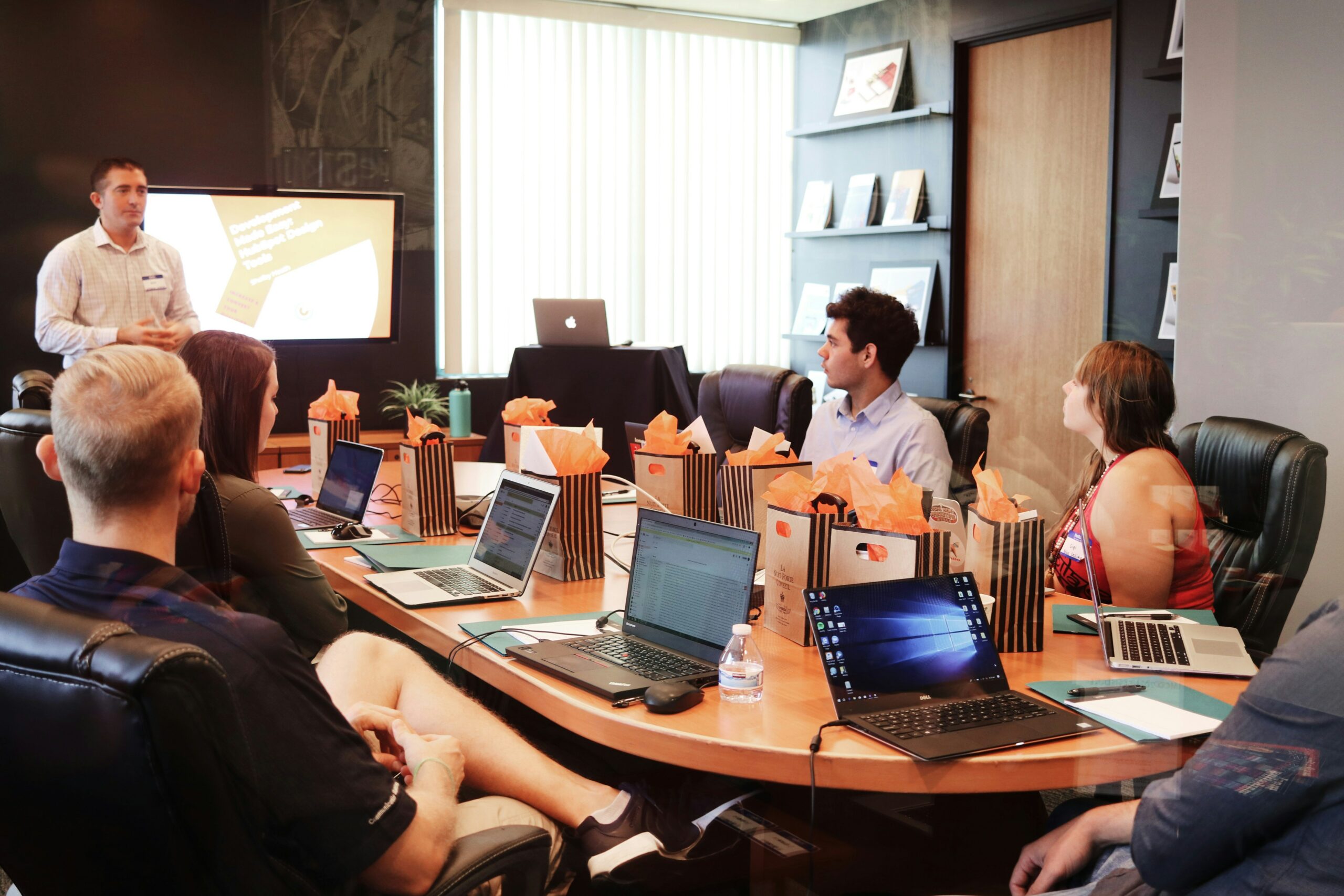 Workshop participants working on laptops around a conference table